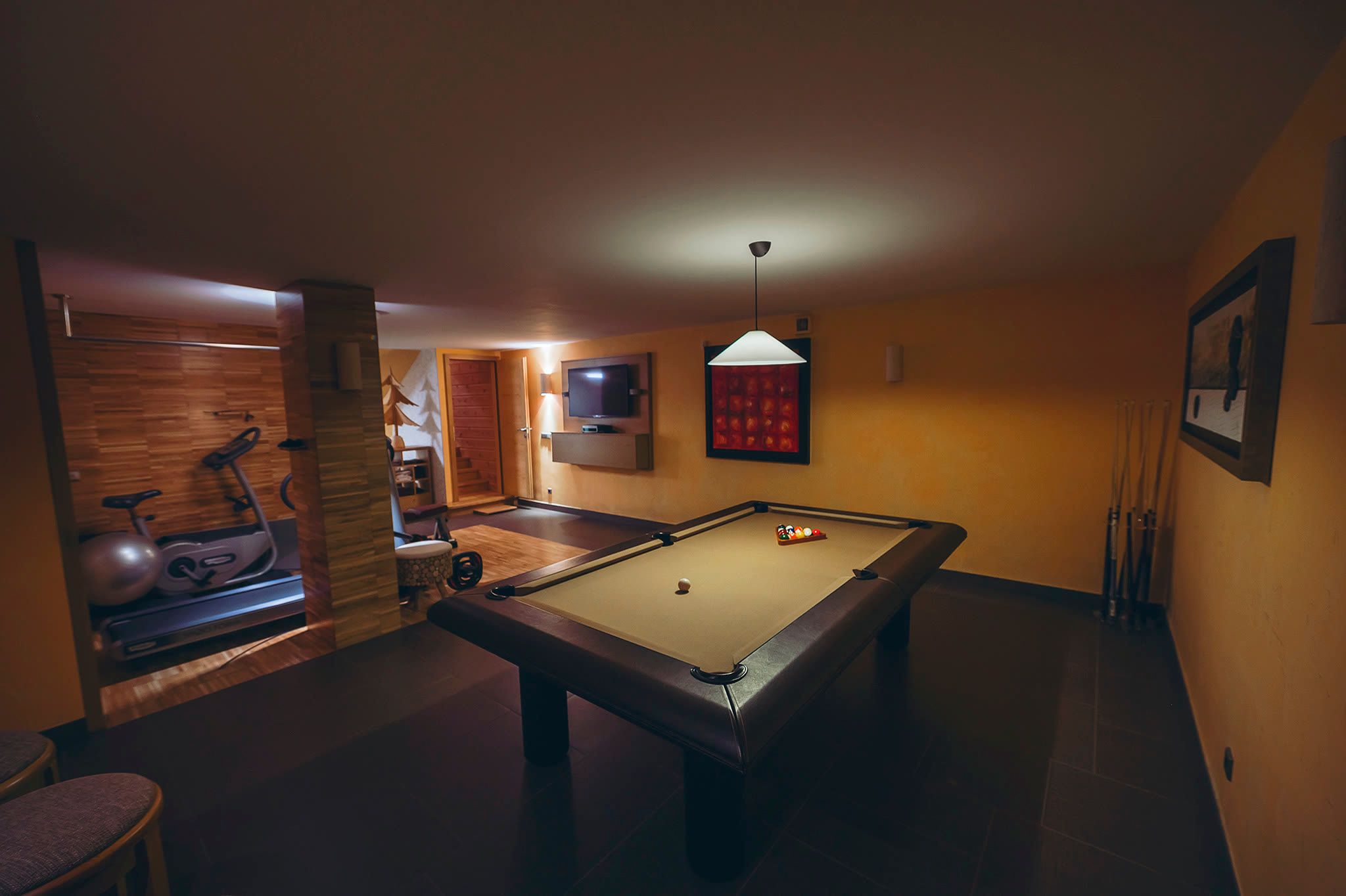 The billiards table with the gym visible through the opening beyond.