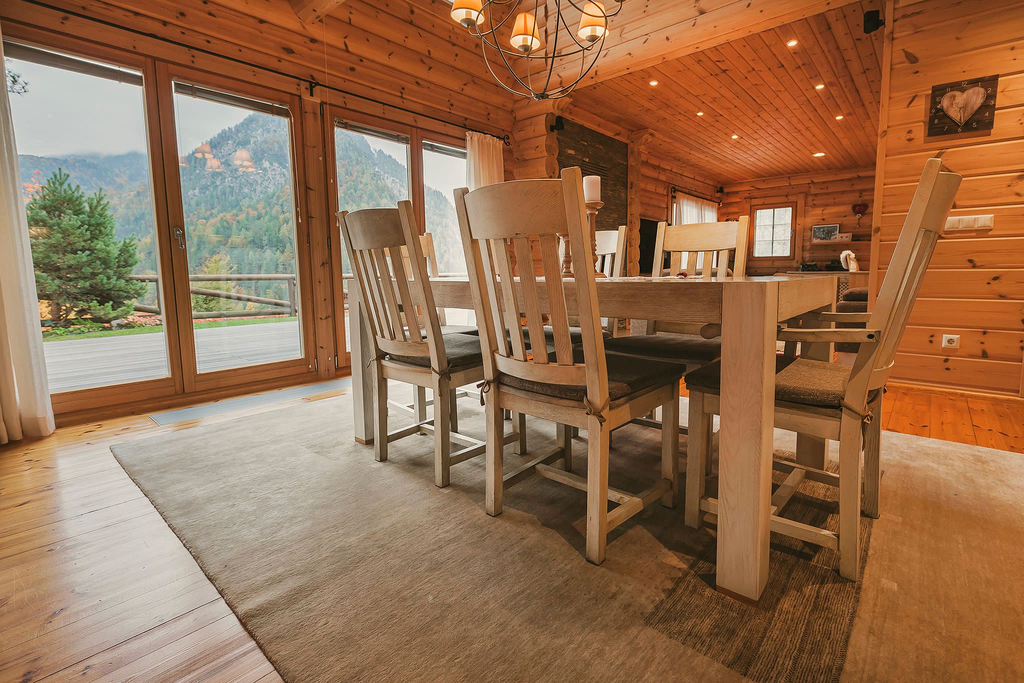 The dining table beside floor-to-ceiling windows, with mountain views visible outside.